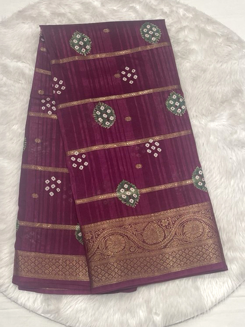 Wine purple Bailu jute silk saree with geometric bandhani print butas and horizontal gold zari stripes.