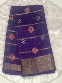 Deep violet Bailu jute saree with traditional gold zari border and scattered bandhani design butas.