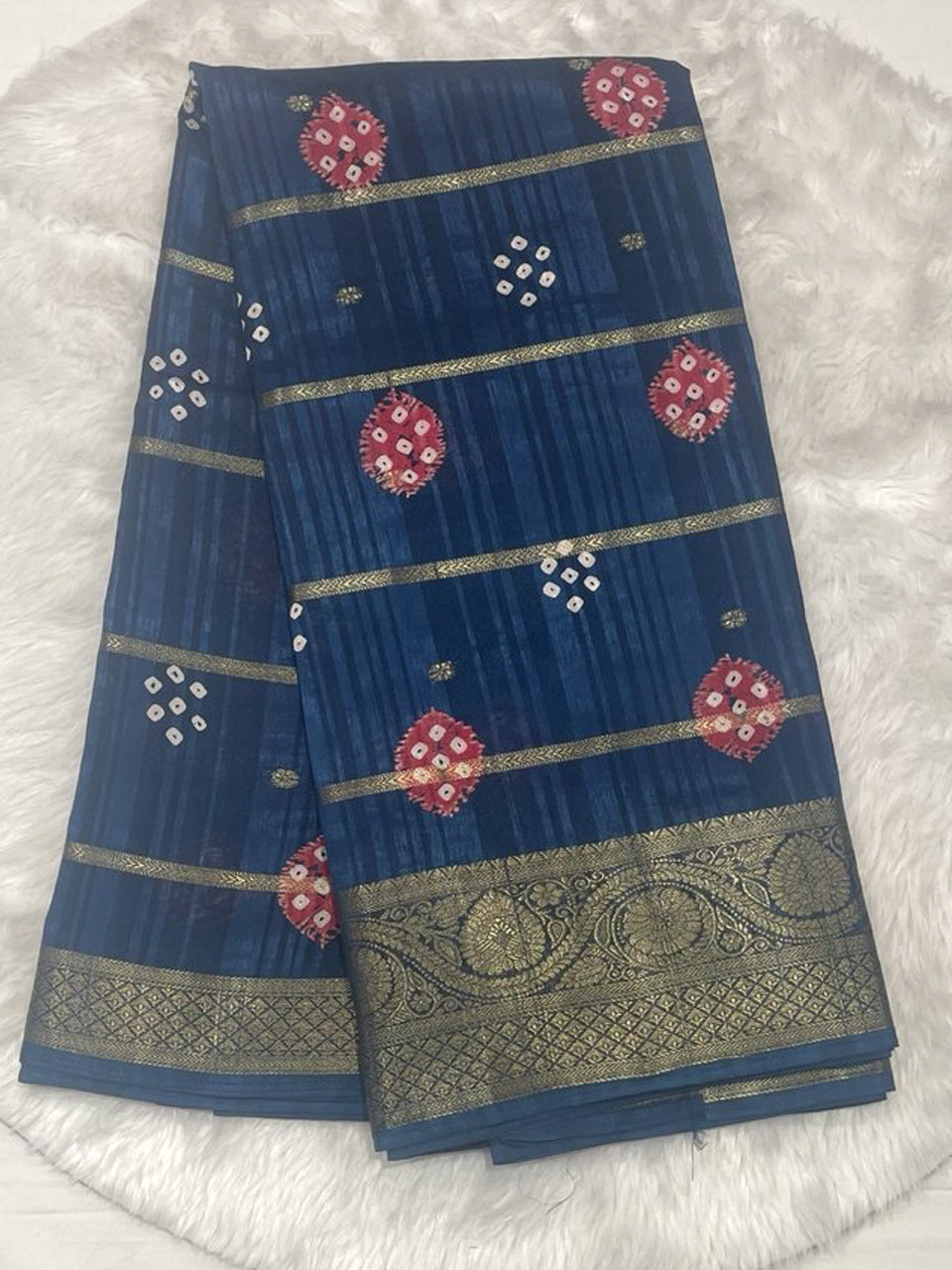 Navy blue Bailu jute saree with horizontal zari lines and bandhani print motifs, finished with a heavy zari border.