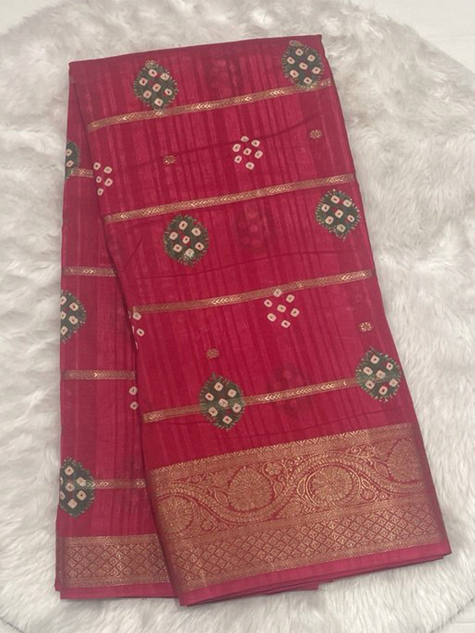 Magenta pink Bailu jute silk saree with gold zari weaving lines and traditional bandhani buta design.
