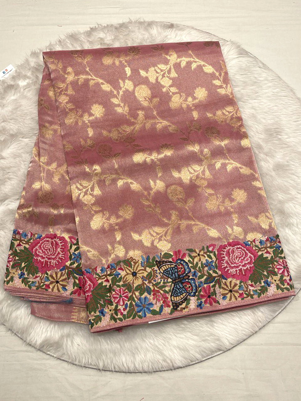 A warm, metallic pink base with gold floral weaving.