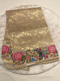 A neutral metallic gold base with matching gold floral weaving.