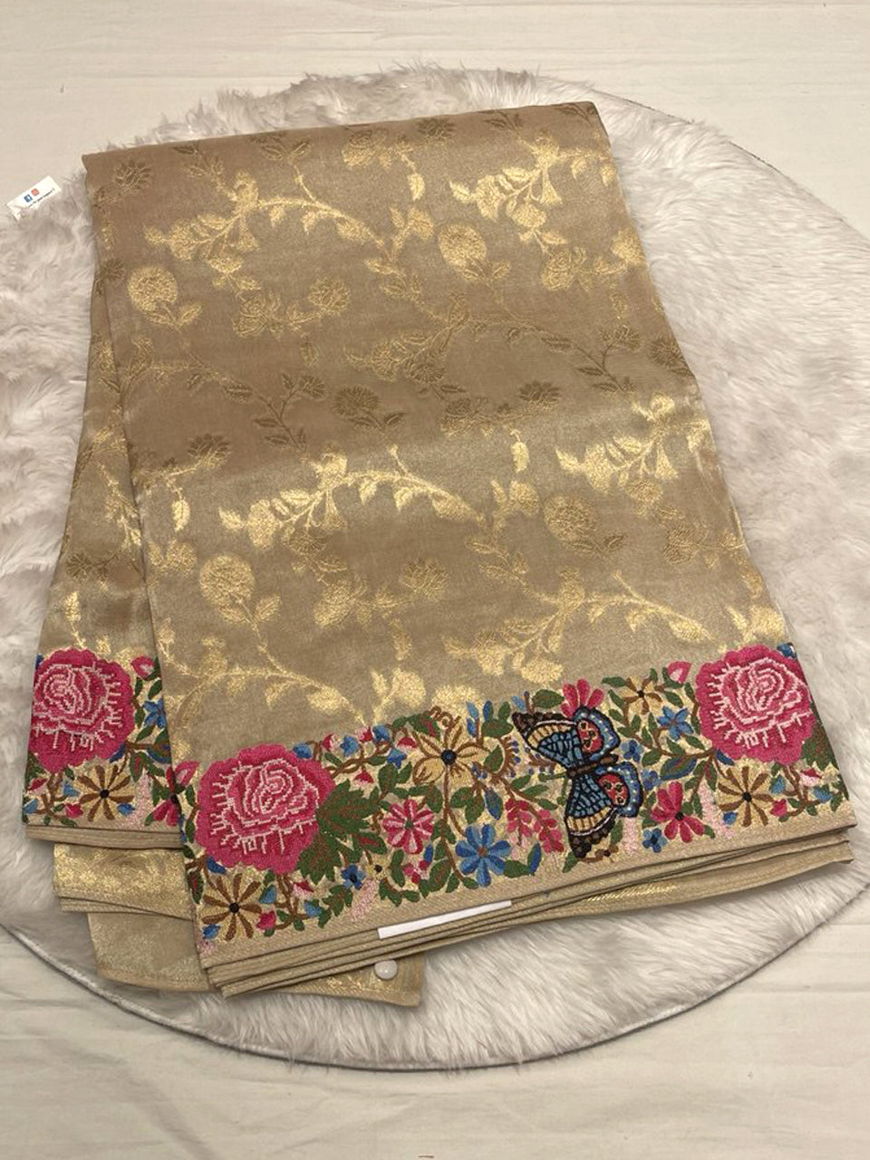 A neutral metallic gold base with matching gold floral weaving.