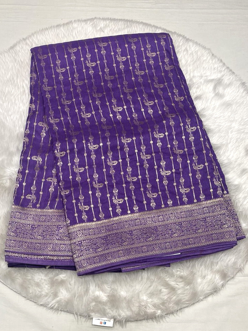 Deep purple Banarasi soft fancy saree with vertical gold zari weaving and bird motifs, featuring a rich zari border.