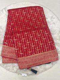 Red Banarasi fancy saree with intricate vertical gold zari weaving and dark green contrast tassels.