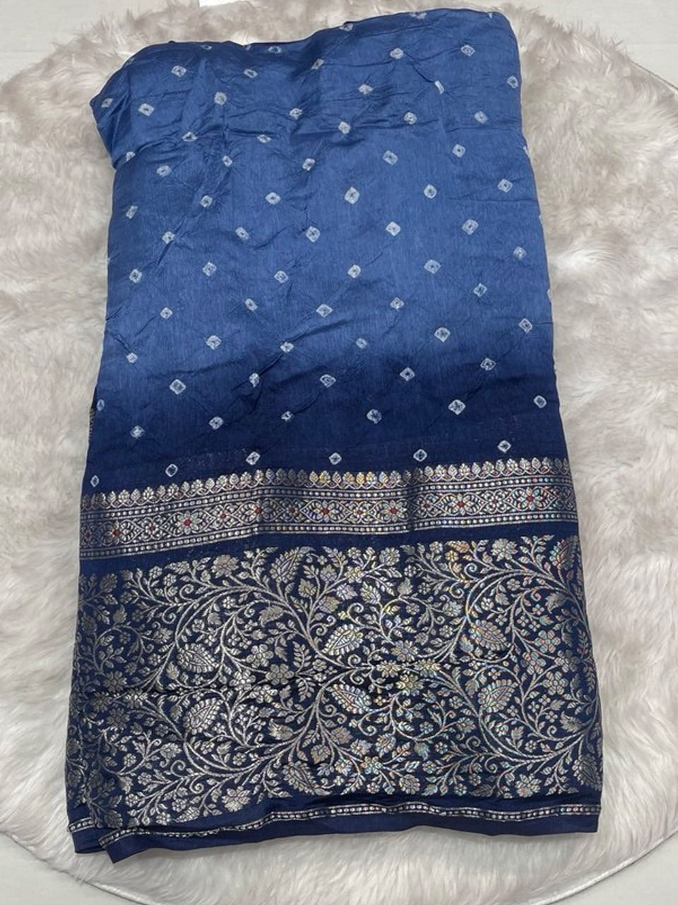 Shaded sky blue and navy blue silk Bandhani saree with a heavy antique gold zari floral border.