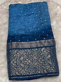 Elegant indigo blue ombré silk Bandhani saree with an antique zari border and floral vine motifs.