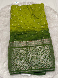 Contemporary dual-tone lime and forest green Bandhani silk saree with a wide decorative gold border.
