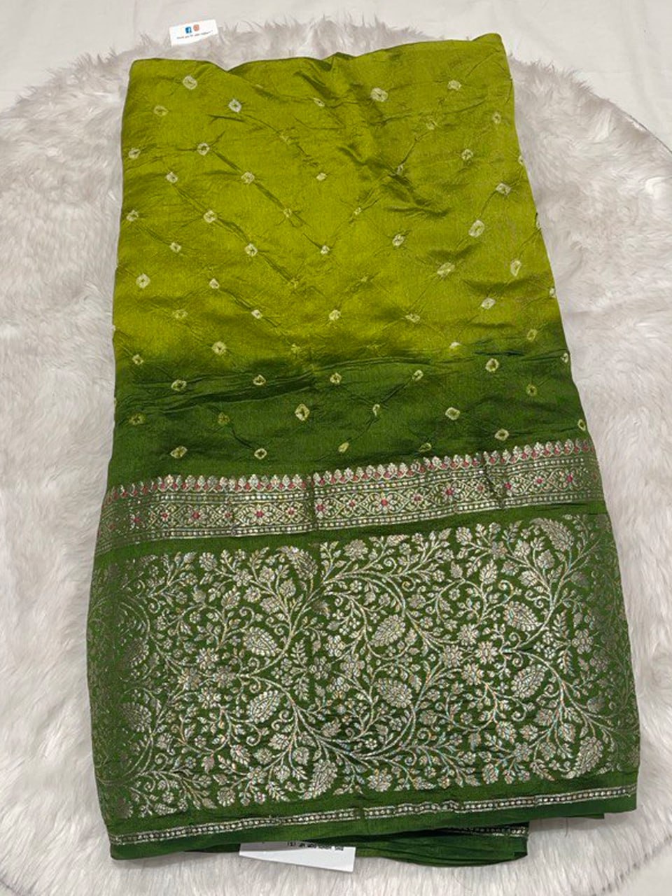 Contemporary dual-tone lime and forest green Bandhani silk saree with a wide decorative gold border.