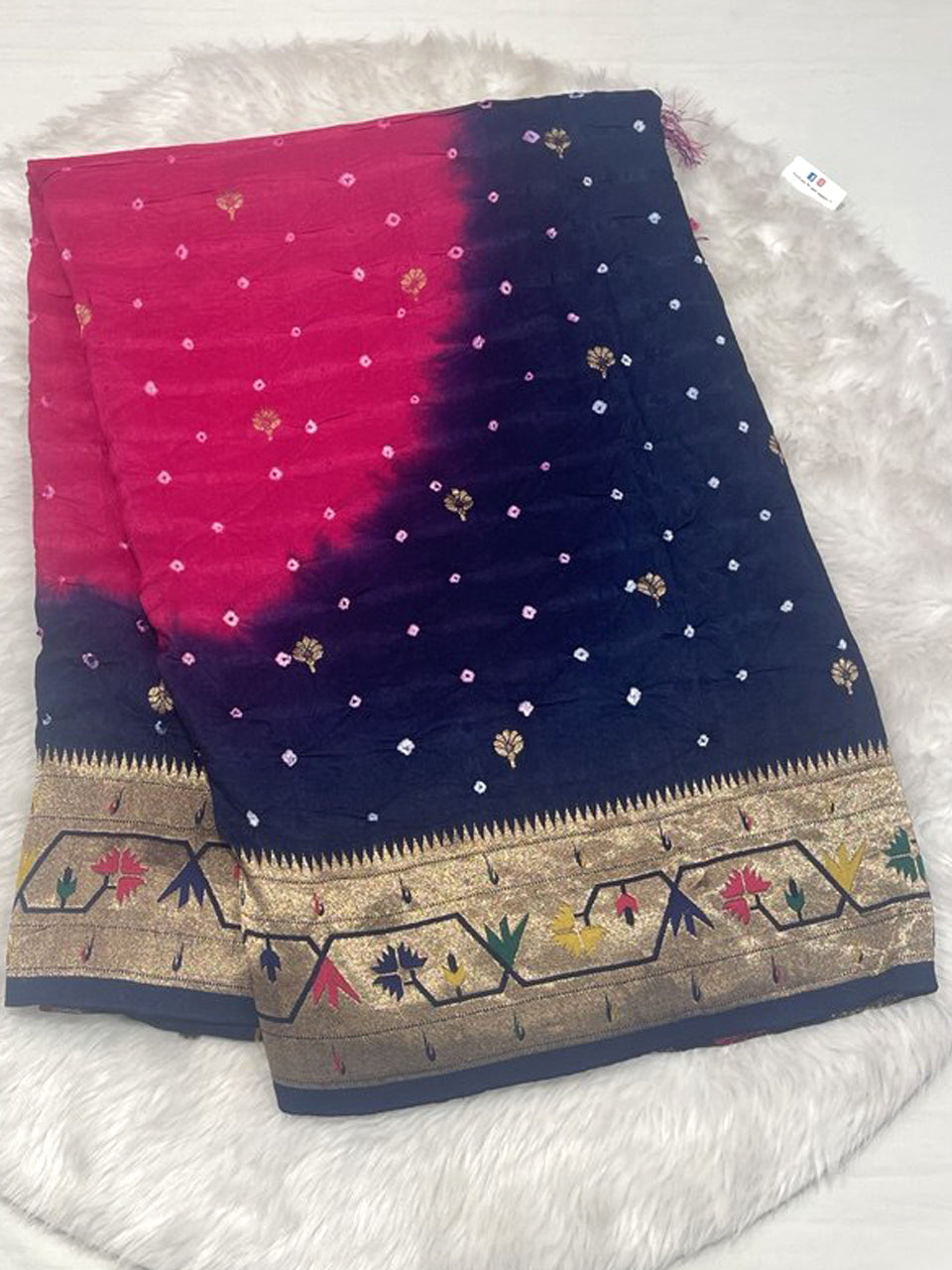 A dual-tone pink and navy blue Banarasi Bandhani silk saree with white Bandhej dots, gold floral buttis, and a broad gold zari border featuring colorful meenakari floral motifs.