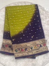 An elegant olive green and deep purple dual-shade Banarasi Bandhani saree with intricate gold zari weaving and a decorative meenakari border.
