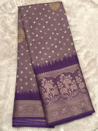 Lavender Banarasi fancy silk saree with a traditional Bandhani design and a rich wine-colored contrast floral border.