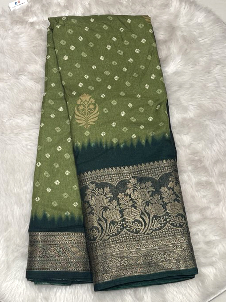 Olive green Banarasi fancy saree with a golden leaf motif and a dark forest green contrast zari border.