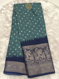 Sea green Banarasi fancy silk saree featuring a navy blue contrast border with intricate gold zari floral patterns.