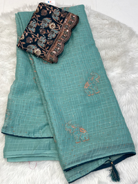 Sea green georgette saree with copper elephant motifs and black embroidered blouse
