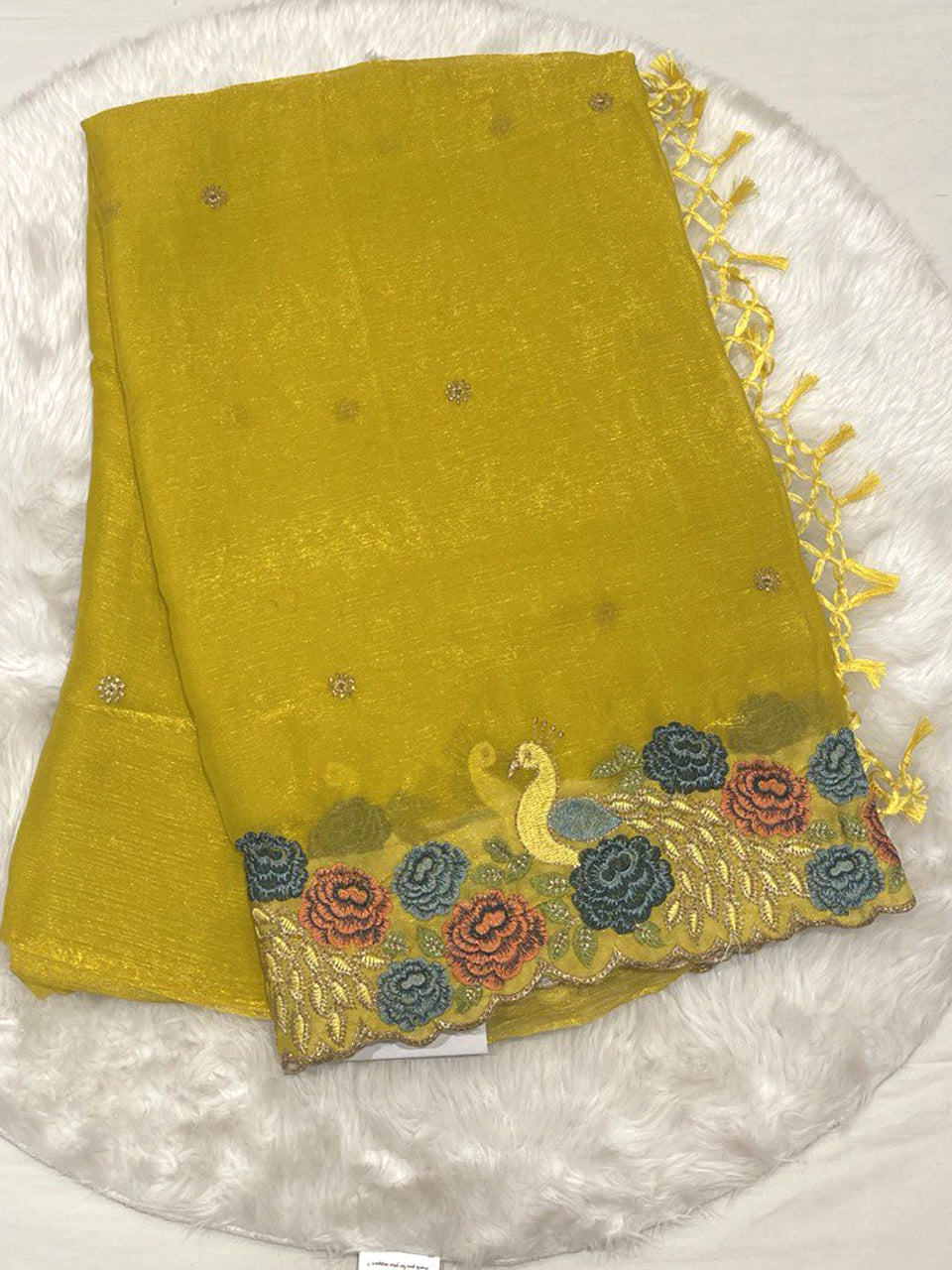 Mustard yellow chiffon silk saree with cutwork embroidery border featuring peacock and floral thread work.
