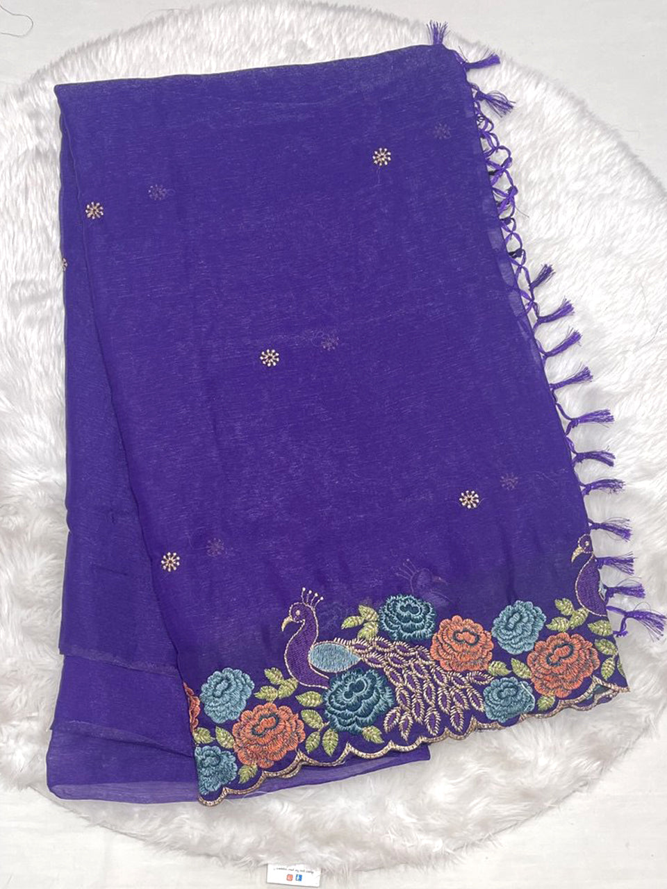 Deep purple chiffon silk saree with scalloped edge border and multi-color thread embroidery work.
