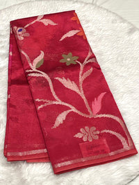 Rich red Dola Silk saree featuring large silver jacquard floral motifs and a sleek border.