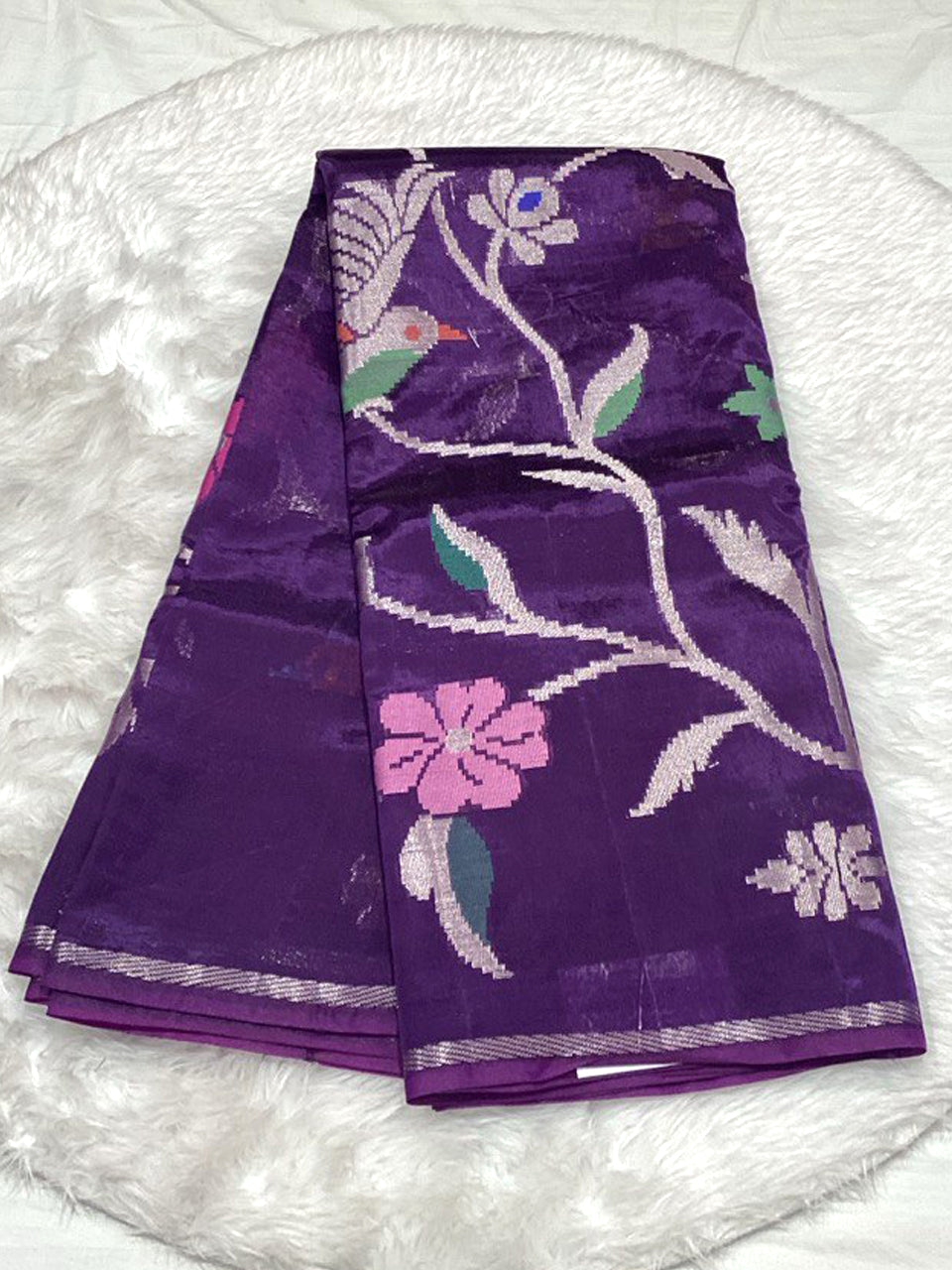 Royal purple Dola Silk saree with shimmering silver jacquard weaving and floral highlights.