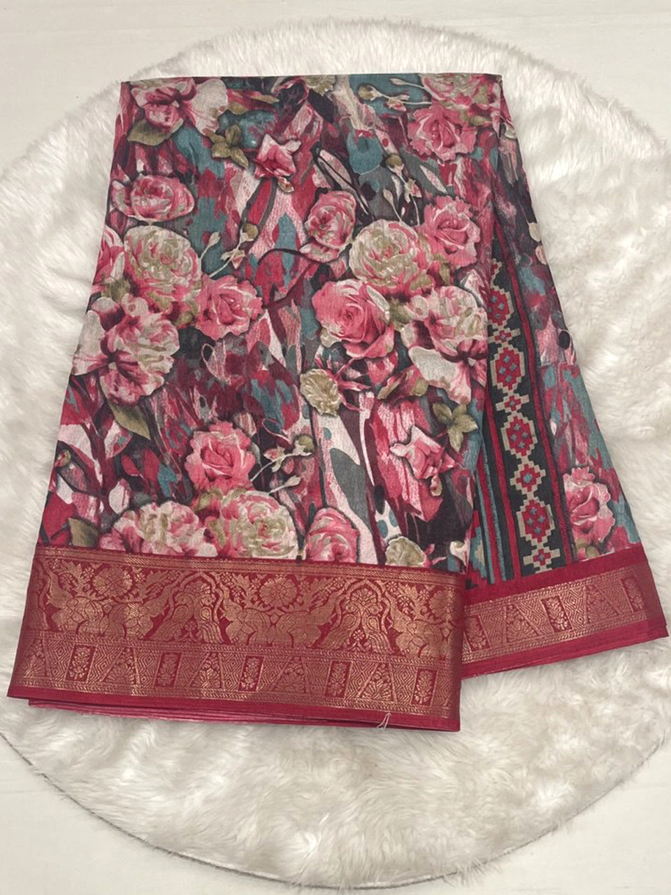 Tomato red crushed fancy saree featuring artistic floral print and a rich traditional gold zari border.