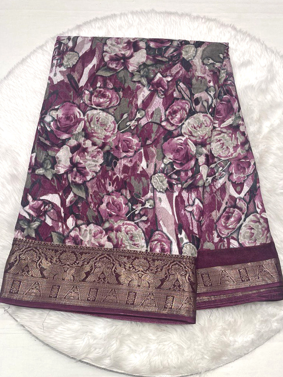 Wine magenta crushed fancy saree with all-over floral design and wide golden zari border.