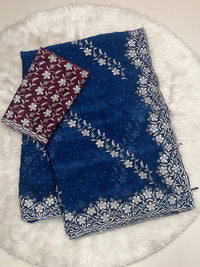 Navy Chiffon Saree with Heavy Silver Zari Floral Cutwork Border and Vibrant Contrast Designer Blouse.