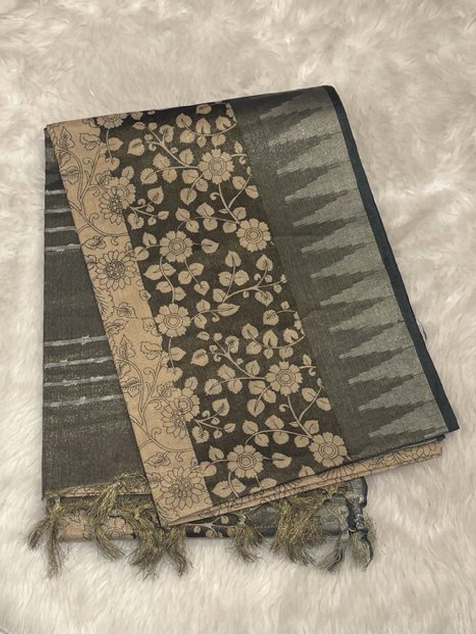 Dark grey jute silk saree featuring silver tissue temple border and intricate floral peacock prints