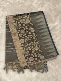 Dark grey jute silk saree featuring silver tissue temple border and intricate floral peacock prints