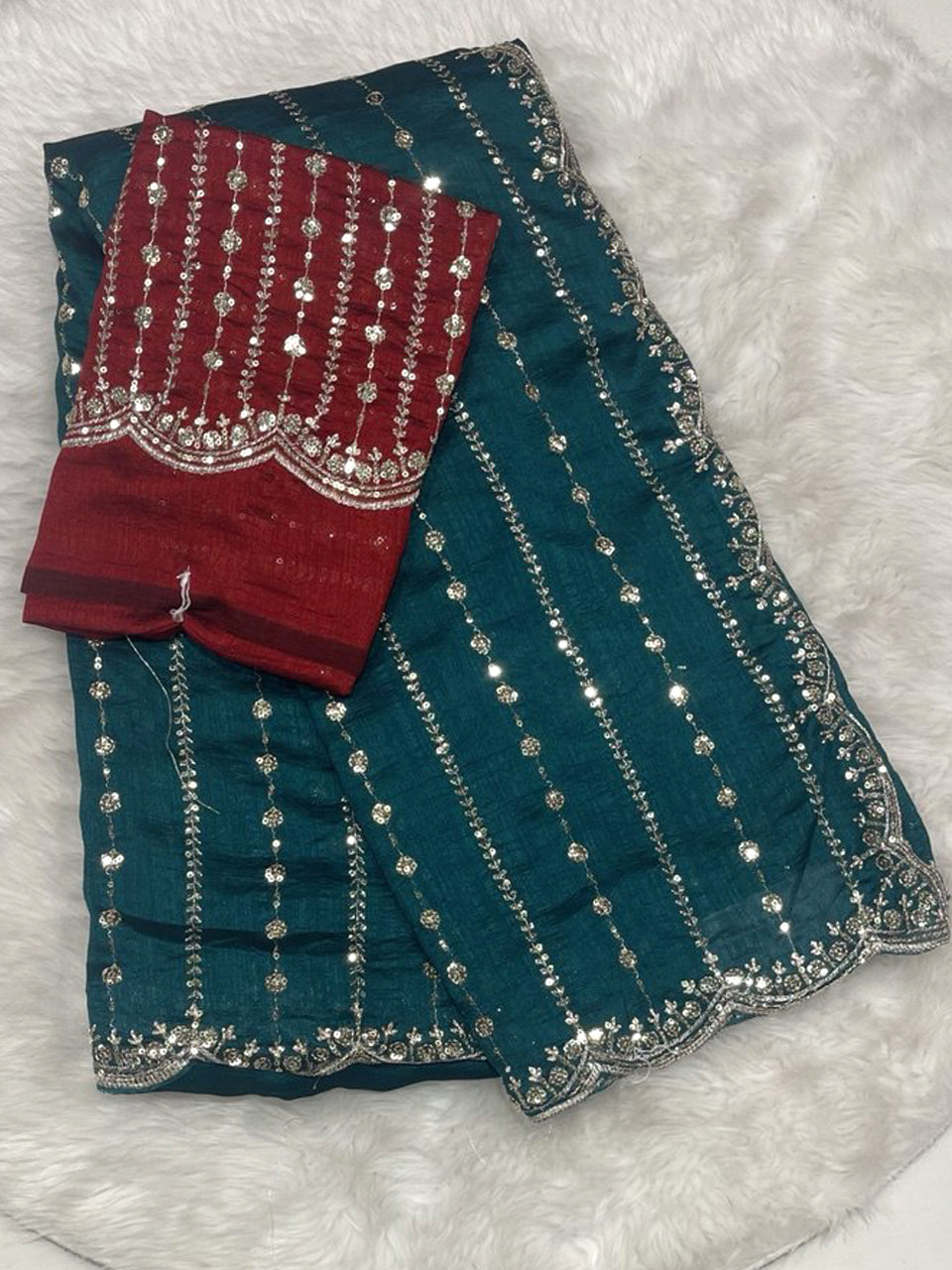 Teal green jute silk saree with vertical sequin lines and cutwork border, paired with a maroon designer work blouse.
