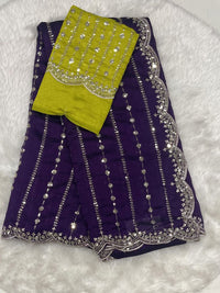 Deep purple party wear saree with gold zari work and scalloped edges, including a lime green heavy work blouse.