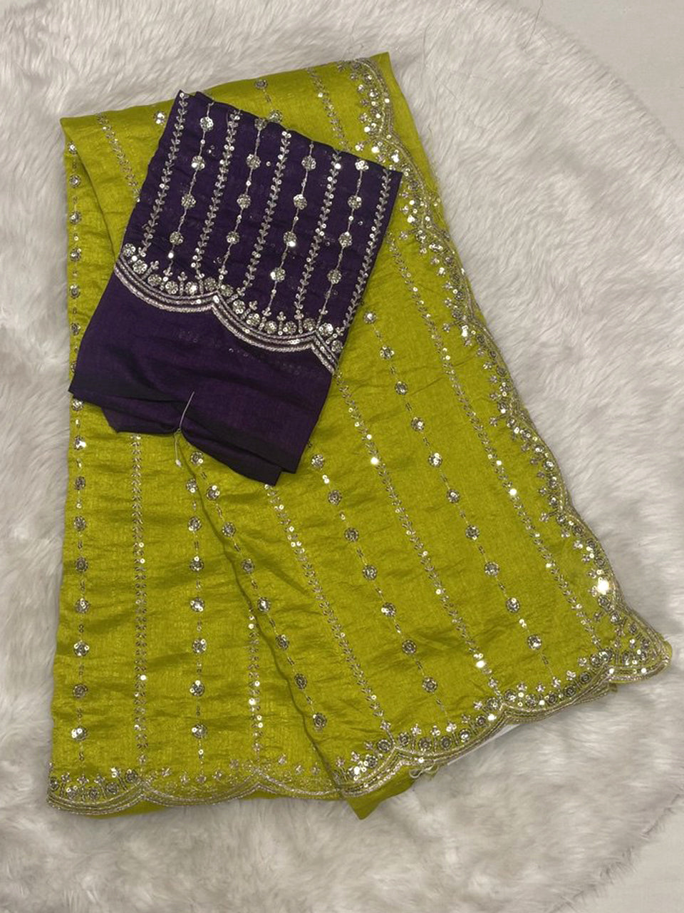 Lime green jute silk saree with sequin detailing and cutwork border, contrasting with a purple designer blouse.