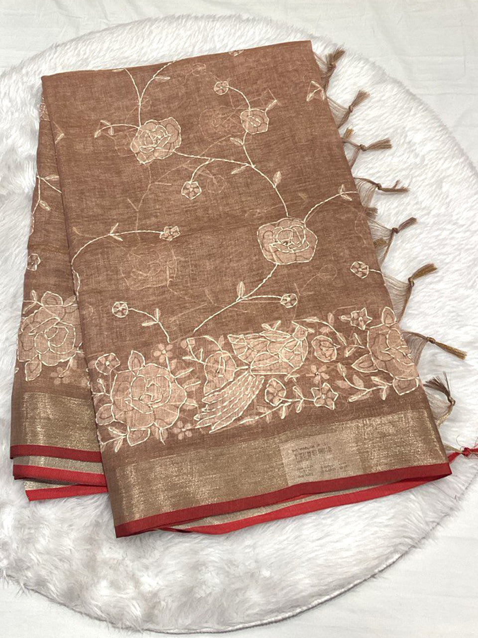 Olive gold Linen Tissue saree with white Lucknowi floral thread work, Zari border, and tassels.