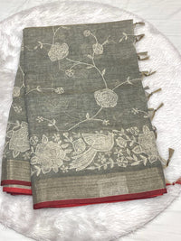 Sage green Linen Tissue saree with white thread Lucknowi work, metallic Zari border, and fringe tassels.