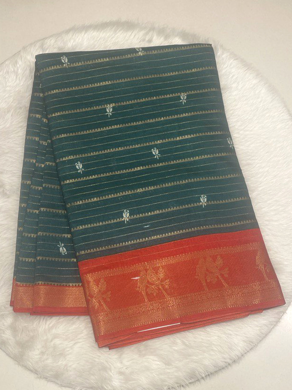 Bottle green Loreal silk saree with horizontal zari stripes and traditional contrast red border with bird weaving.