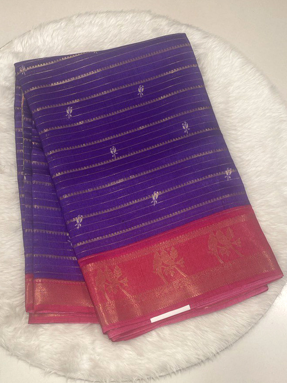 Violet purple Loreal silk saree with contrast pink border, gold zari bird motifs, and horizontal metallic stripes.