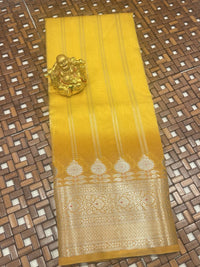 Yellow Chiniya Fancy Saree with standing zari lines and grand antique floral border for festivals.