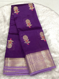 Royal purple semi-silk saree featuring intricate gold mango buttis and a broad lavender-toned gold Zari border for festive wear.