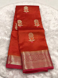 Burnt orange Semi Green Mango silk saree featuring woven gold Zari mango buttis and a broad fuchsia pink and gold floral Zari border.
