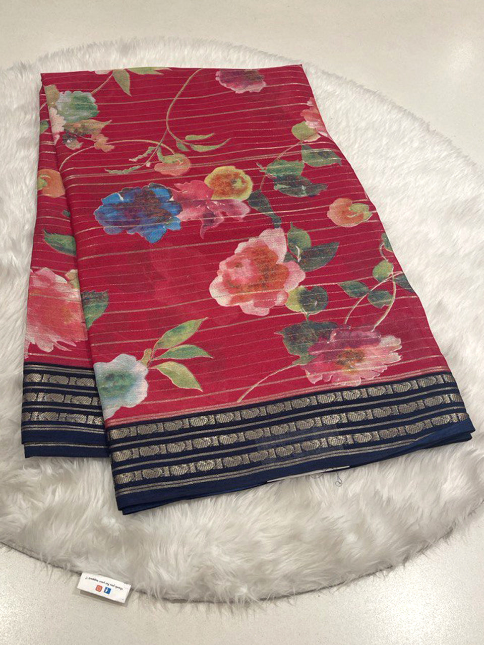Red Micro Chiffon saree with floral design, horizontal zari stripes, and navy blue border.