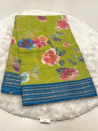 Lime Green Micro Chiffon saree with pink flowers and blue contrast zari border.