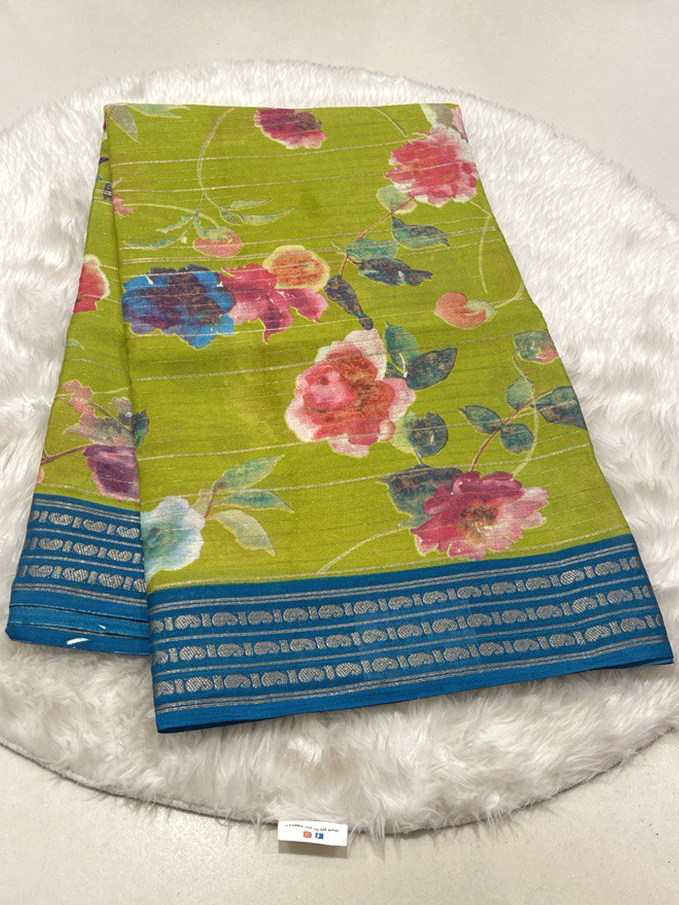 Lime Green Micro Chiffon saree with pink flowers and blue contrast zari border.