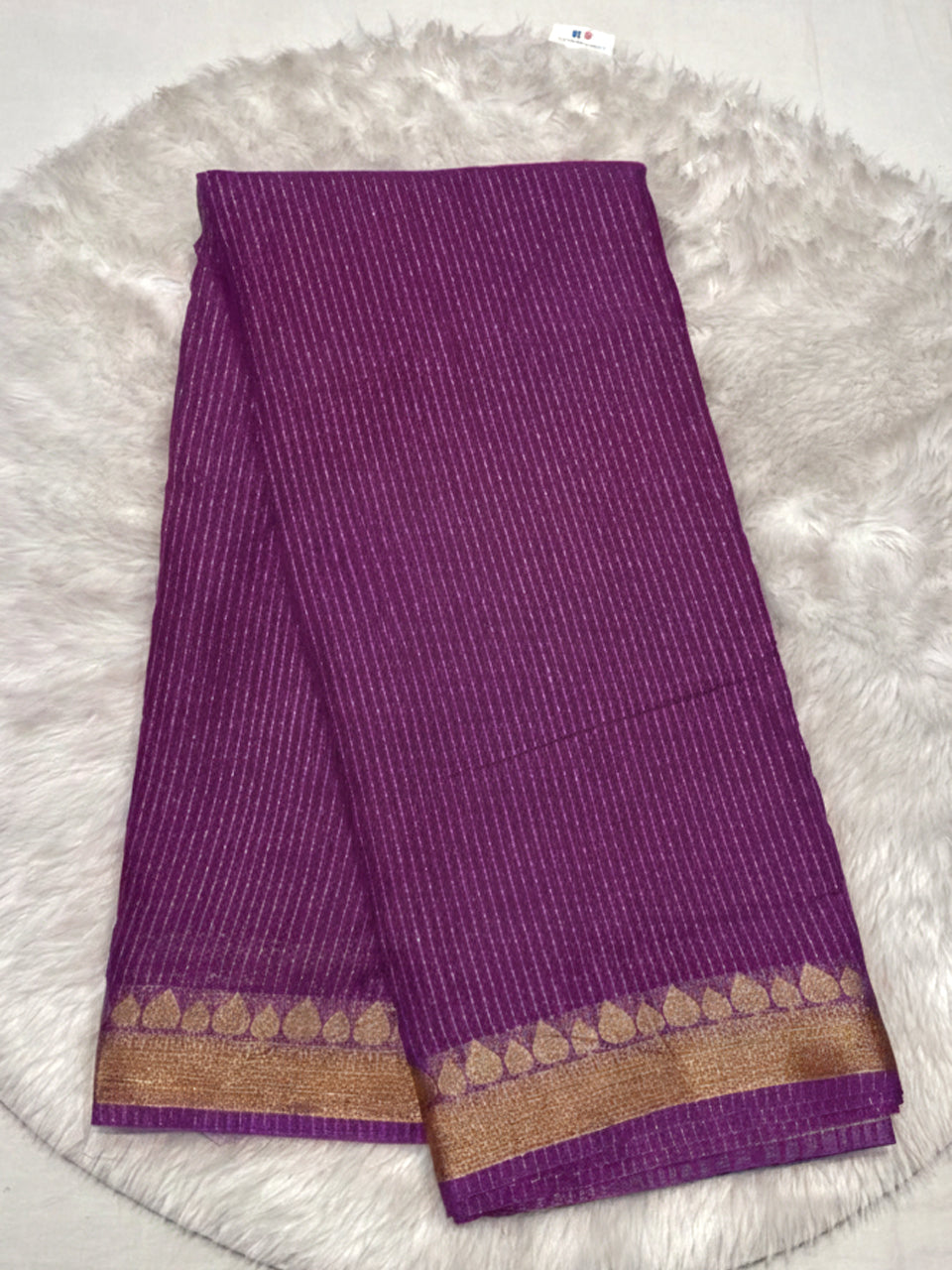 Deep magenta purple georgette saree with shimmering gold lines and zari border