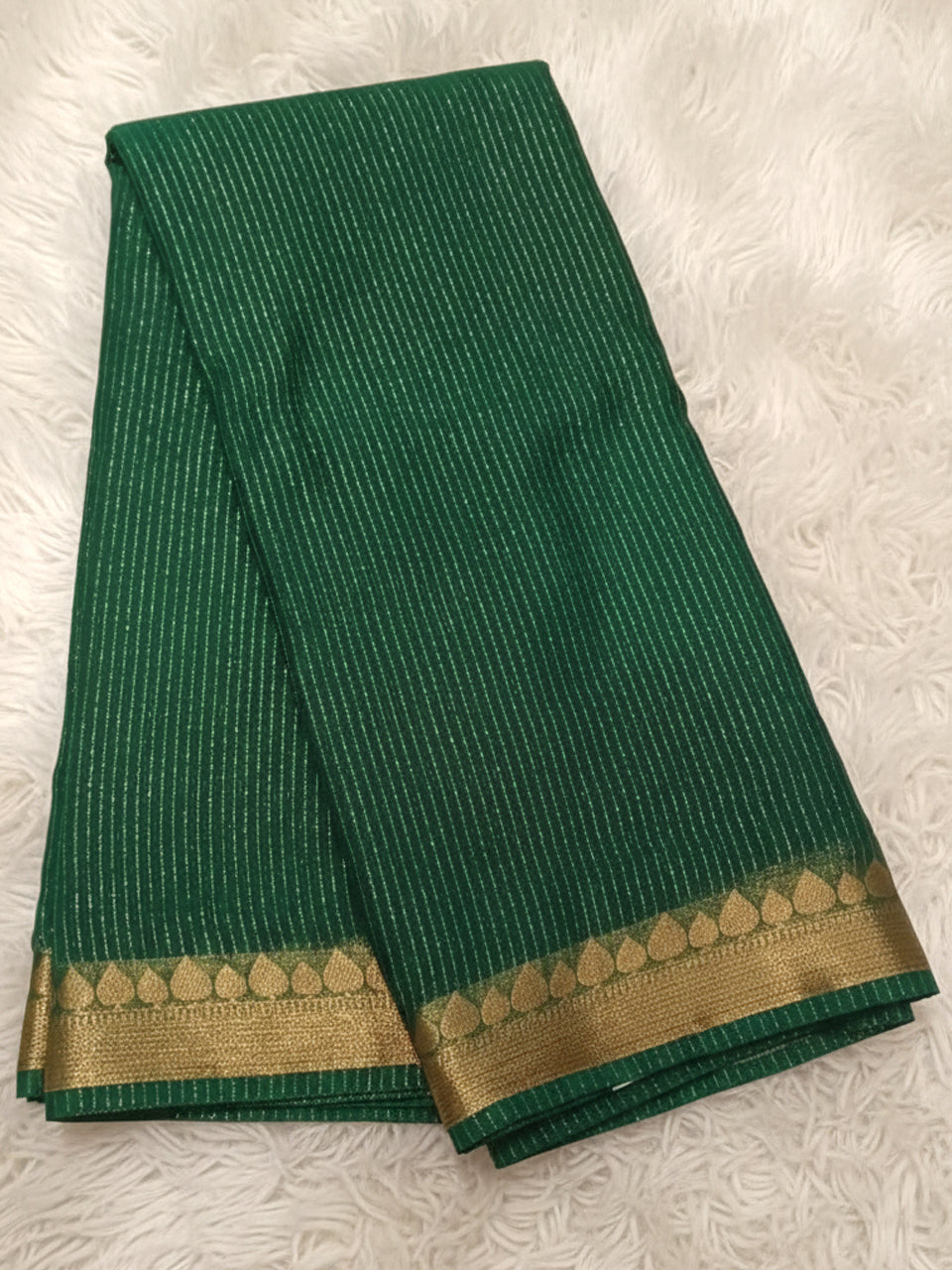 Forest green georgette saree with gold zari stripe work and traditional border