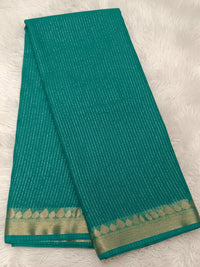 Teal green millennium georgette saree with vertical shimmer lines and gold border