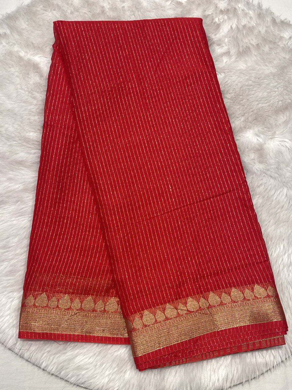 Classic red millennium georgette saree with gold zari stripes and designer border