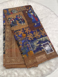 Deep indigo blue Meena cotton saree featuring mythological folk art and a contrasting gold border.