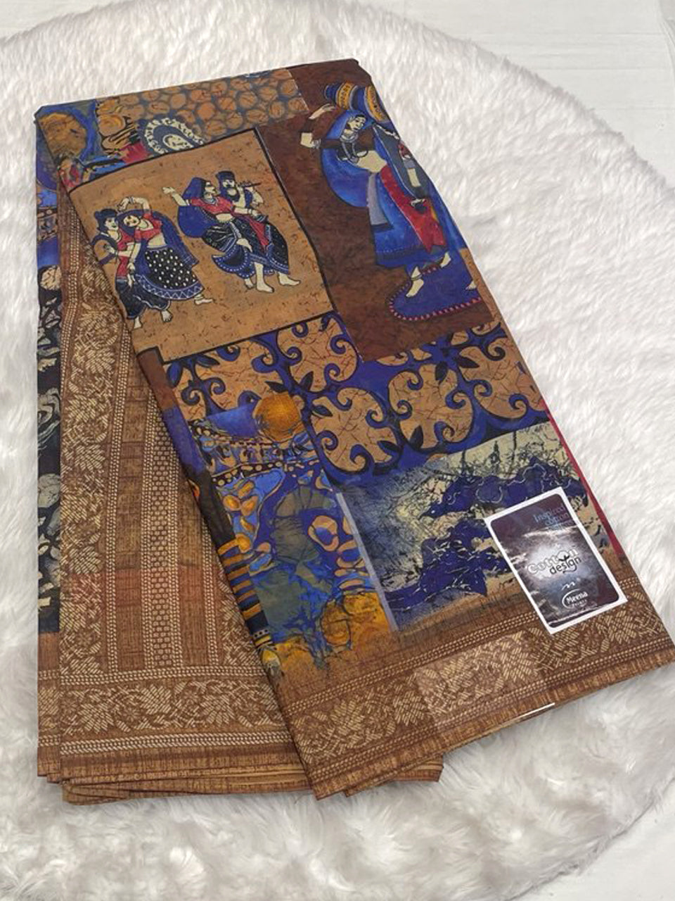 Deep indigo blue Meena cotton saree featuring mythological folk art and a contrasting gold border.
