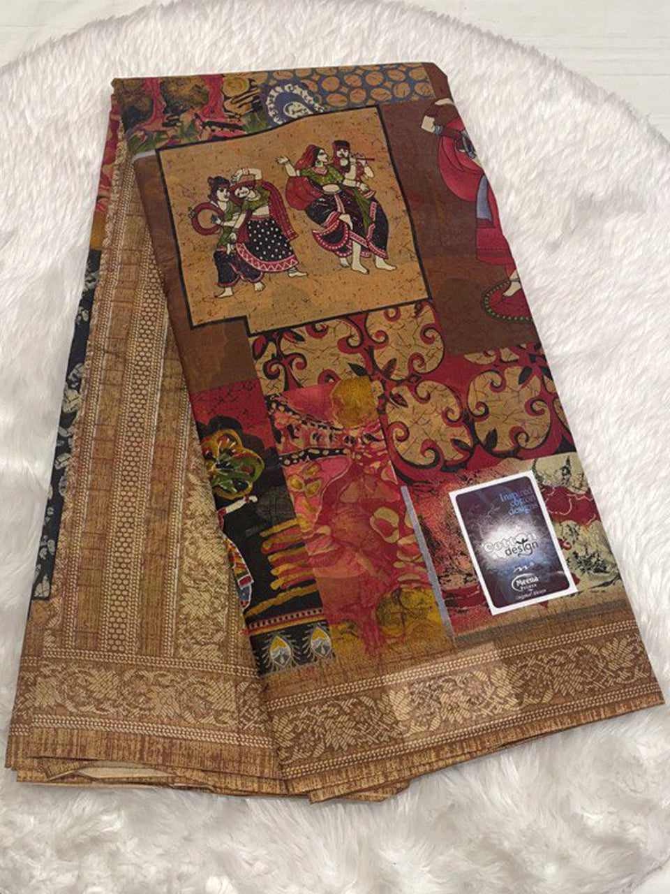 Neutral tan and brown Meena cotton saree with detailed patchwork folk-art illustrations.