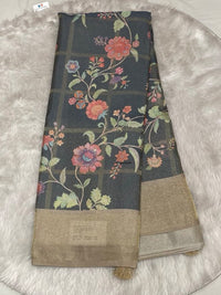 Charcoal grey Muslin Tissue saree featuring a grid-check pattern, colorful floral digital prints, and a wide gold tissue border.