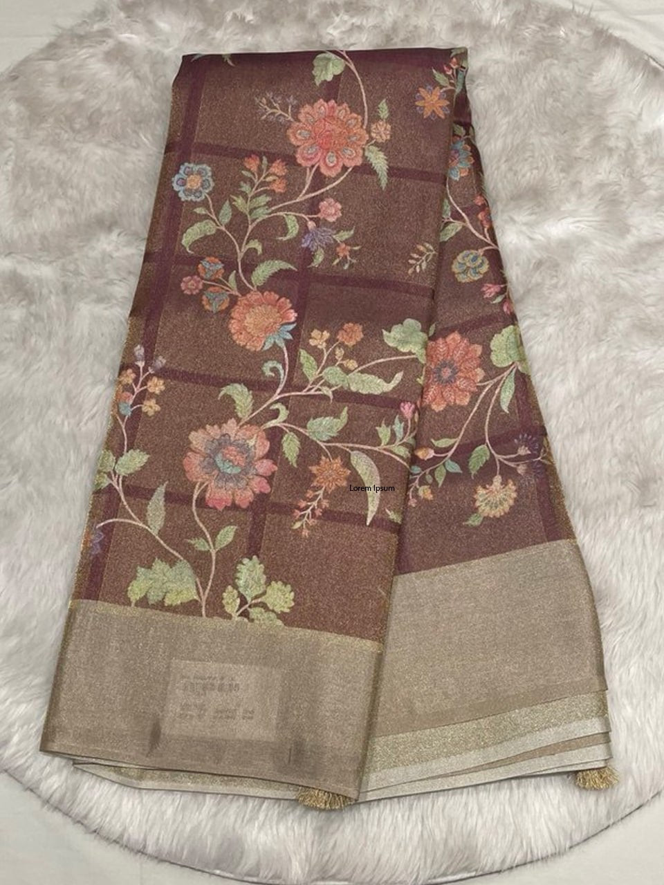 Deep plum-toned Muslin Tissue saree with large floral vine motifs and a shimmering solid gold border.